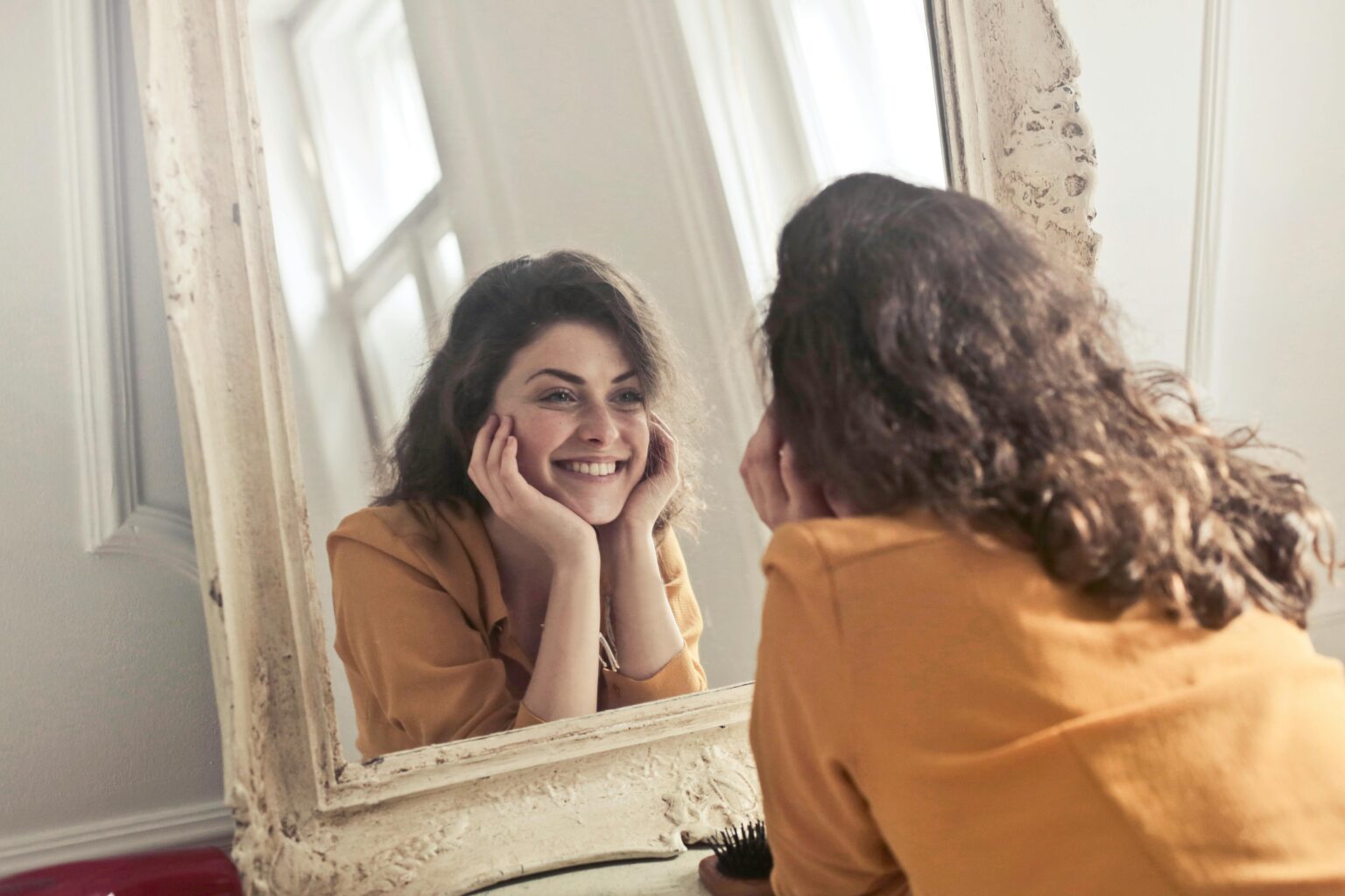 Female Looking Confidently into the mirror. Photo by Andrea Piacquadio